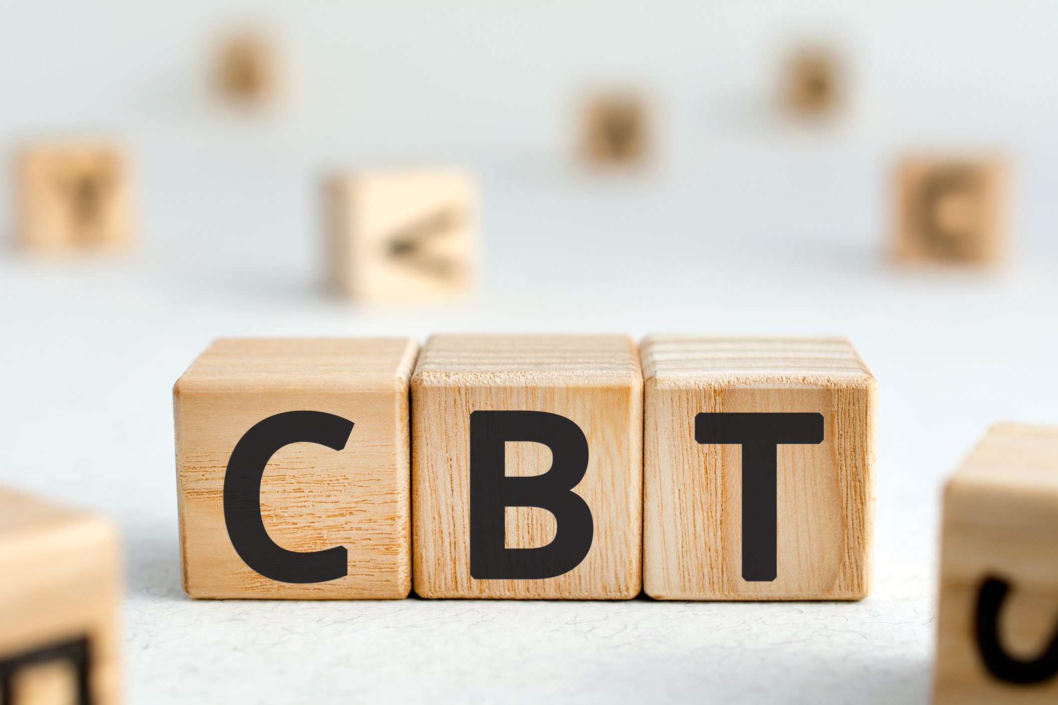 Wooden blocks on white backdrop spelling "CBT".